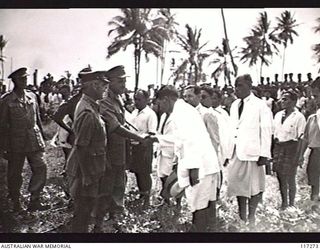 NAURU ISLAND. 1945-09-14. BRIGADIER J. R. STEVENSON DSO, COMMANDING 11TH AUSTRALIAN INFANTRY BRIGADE AND MEMBERS OF THE OFFICIAL PARTY RECEIVING NATIVE CHIEFS AT THE CONCLUSION OF THE AUSTRALIAN ..