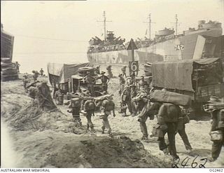 RED BEACH, MOROTAI ISLAND, HALMAHERA ISLANDS, NETHERLANDS EAST INDIES. 1945-04-23. ENGINEERS OF NO. 61 AIRFIELD CONSTRUCTION WING RAAF WHO TOOK PART IN THE TARAKAN OPERATIONS SAY FAREWELL TO ..