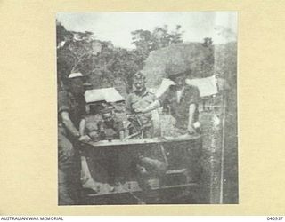 Dumpu, New Guinea. 1944-01. Four members of the 58/59th Australian Infantry Battalion with a two pounder Tank Attack gun