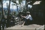 Ann Rappaport sits outside her house with women and children