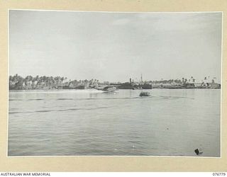 MADANG, NEW GUINEA. 1944-10-31. THE RAAF COURIER AIRCRAFT, A MARTIN MARINER ALIGHTS ON THE WATERS OF THE HARBOUR