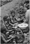 Nancy Cook giving salt to Kwiop women, who have brought sweet potatoes to exchange