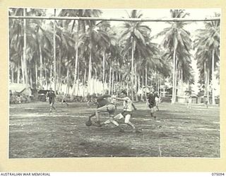 MILILAT, NEW GUINEA. 1944-08-06. A TENSE MOMENT DURING THE SOCCER MATCH BETWEEN TEAMS FROM THE 4TH INFANTRY BRIGADE AND HEADQUARTERS, 5TH DIVISION DURING THE FIRST GAME PLAYED ON THE NEW ..