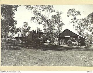 KOITAKI, PORT MORESBY AREA, PAPUA, NEW GUINEA. 1944-03-27. THE FRONT ENTRANCE TO THE AUSTRALIAN ARMY EDUCATION SERVICE LIBRARY AT THE 113TH CONVALESCENT DEPOT SHOWING THE GARDENS AND A PORTION OF ..