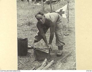 KOROPA, NEW GUINEA. 1944-02-03. VX139884 CORPORAL A.M. JENKINS (1) MAKING COFFEE AT A SALVATION ARMY STALL. THE 15TH INFANTRY BRIGADE HEADQUARTERS ESTABLISHED STALLS AND REST POINTS ALONG THE TRAIL ..