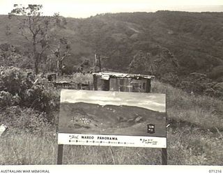 FINSCHHAFEN AREA, NEW GUINEA, 1944-03-17. ONE OF MANY BATTLE SIGNS IN THE FINSCHHAFEN AREA, THIS SKETCH OF THE WAREO PANORAMA INDICATES THE POSITIONS OF FIOR, SONG RIVER CROSSING, KUNAI, KUANKO, ..