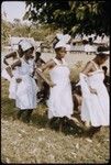 Female dancers in white dresses with red trim