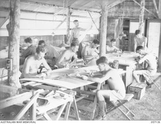 SEVENTEEN MILE, NEW GUINEA. 1943-09-23. DRAFTING SECTION OF THE 2/1ST AUSTRALIAN ARMY TOPOGRAPHICAL SURVEY COMAPNY. SHOWN: NX53223 CORPORAL (CPL) C. E. THEILE (1); NX147136 CPL B. A. HALPIN (2); ..