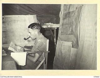 BOUGAINVILLE ISLAND, 1945-01-21. NX111086 MAJOR V.J.M. TRUDA, 2ND FIELD REGIMENT, WORKING IN THE HEADQUARTERS COUNTER BATTERY ROOM
