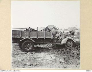 CAPE WOM, WEWAK AREA, NEW GUINEA. 1945-08-30. A CAPTURED JAPANESE TRUCK EXPERIENCING DIFFICULTIES AT 2/42 LIGHT AID DETACHMENT, CORPS OF AUSTRALIAN ELECTRICAL AND MECHANICAL ENGINEERS