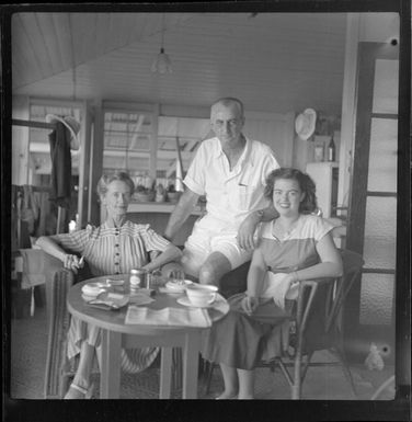 Mr and Mrs C Corbett with an unidentified girl [their daughter?] inside their house in Fiji