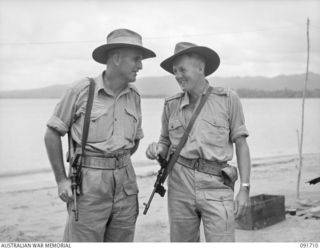CAPE WOM, WEWAK AREA, NEW GUINEA. 1945-05-06. A CLOSE UP OF WARRANT OFFICER 2 H. WALBY (1), AND LIEUTENANT J.A. BIRRELL (2), AUSTRALIAN NEW GUINEA ADMINISTRATIVE UNIT PATROL OFFICERS ATTACHED TO 19 ..