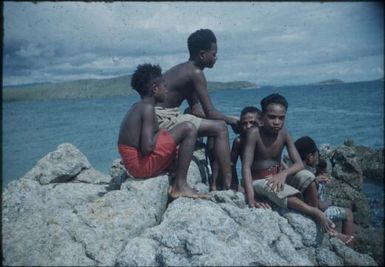 Raku boys near the sea, on the rocks : Port Moresby, Papua New Guinea, 1953 / Terence and Margaret Spencer