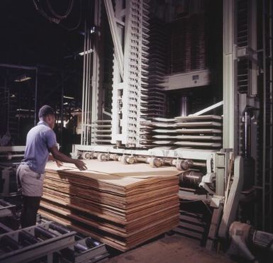 Klinki timber veneer glue spreader and hot press, Bulolo, Morobe Province, Papua New Guinea, approximately 1968 / Robin Smith