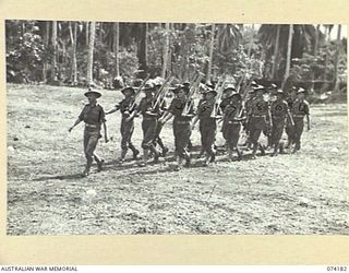 SIAR, NEW GUINEA. 1944-06-22. PERSONNEL OF NO.4 PLATOON, HEADQUARTERS COMPANY, 57/60TH INFANTRY BATTALION MOVING OFF THE UNIT PARADE GROUND AT THE CONCLUSION OF THE MORNING PARADE. IDENTIFIED ARE:- ..