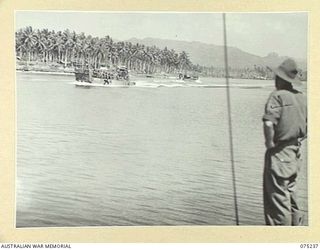 NAGADA, NEW GUINEA. 1944-08-18. SX282252 PRIVATE C.H. RICHARDSON, NEW GUINEA SEA AMBULANCE TRANSPORT COMPANY (1), ACTING AS A LOOKOUT AS THE UNIT MEDICAL LAUNCH AM1567 APPROACHES THE LANDING STAGE ..