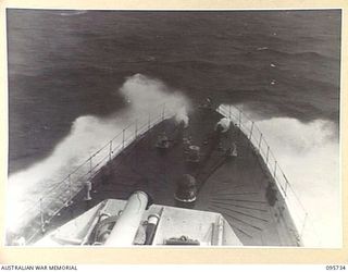 AT SEA OFF RABAUL, NEW BRITAIN. 1945-09-04. WATER BREAKING OVER THE BOWS OF HMAS VENDETTA, AS SHE RETURNS TO JACQUINOT BAY AFTER PRE- SURRENDER DISCUSSIONS AT A SEA RENDEZVOUS OFF RABAUL BETWEEN ..