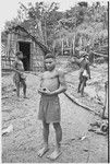 Men in front of Rappaport's house, man on right wears hornbill ornaments