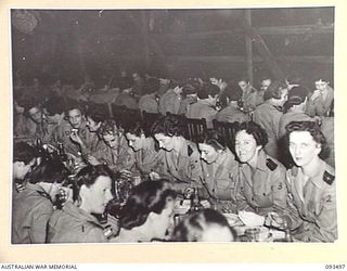 TOROKINA, BOUGAINVILLE. 1945-07-02. A GROUP OF AUSTRALIAN ARMY NURSING SERVICE SISTERS IN THE SISTERS' MESS, 2/1 GENERAL HOSPITAL DURING A FORMAL DINNER CELEBRATING THE 43RD ANNIVERSARY OF THE ..