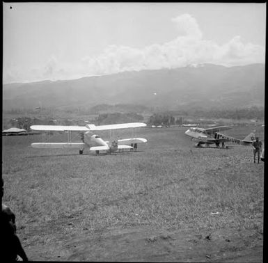 Two bi-planes, one marked VH-UVB, New Guinea, ca. 1936 / Sarah Chinnery