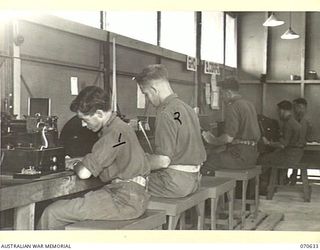 PORT MORESBY, PAPUA, 1944-02-26. THE TELEGRAPH ROOM SHOWING THE WHEATSTONE AND TELETYPE EQUIPMENT IN THE NEW GUINEA FORCE SIGNALS OFFICE WHICH IS MANNED BY PERSONNEL OF THE 18TH LINES OF ..