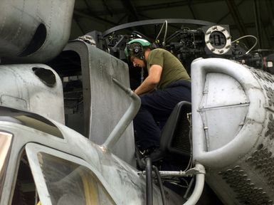 Lance Corporal Drue N. McIver, from HMH-463 Kaneohe Bay Hawaii, puts a CH-53E Super Stallion helicopter that was disassembled so it could be transported to Anderson Air Force Base, Guam, back together as part of Exercise KOA THUNDER 2001 at Anderson Air Force Base. Marines from Aviation Support Element, Kaneohe Bay, Hawaii, 1ST Marine Air Wing, Okinawa, Japan, and 3rd Marines 7th Battalion, 29 Palms, California, participated in KOA THUNDER on the island of Guam from July 9 to July 14. The purpose of the exercise was to demonstrate the Marine Corps' ability to deploy in the South Pacific from places other than Okinawa, Japan