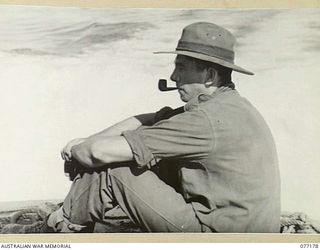 MALMAL MISSION, JACQUINOT BAY, NEW BRITAIN. 1944-11-24. V195226 PRIVATE R.N. FYSH, HEADQUARTERS COMPANY, 14/32ND INFANTRY BATTALION RELAXING INTHE STERN OF THE AUSTRALIAN COURIER BARGE AS IT MOVES ..