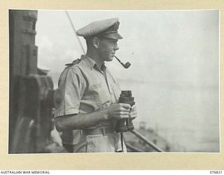 JACQUINOT BAY, NEW BRITAIN. 1944-11-08. LIEUTENANT P.I. POWELL, RAN, GUNNERY OFFICER ABOARD THE RAN FRIGATE, BARCOO