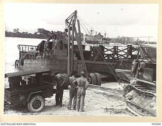 PURUATA ISLAND, SOUTH BOUGAINVILLE. 1945-05-29. A LE TOURNEAU CRANE BEING USED BY 42 LANDING CRAFT COMPANY TO RAISE THE STERN OF A LANDING CRAFT MECHANISED CLEAR OF BEACH TO LAUNCH CRAFT