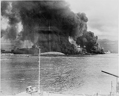 Naval photograph documenting the Japanese attack on Pearl Harbor, Hawaii which initiated US participation in World War II. Navy's caption: Battleship row after the Japanese attack on Pearl Harbor of Dec. 7, 1941.