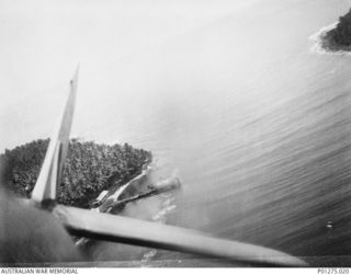 Jacquinot Bay Area, New Britain. 1943-09-27. Aerial photograph of an `A' type Japanese barge burning near the shore after a strafing run by Beaufighter aircraft of No. 30 Squadron RAAF. (Donor F. ..