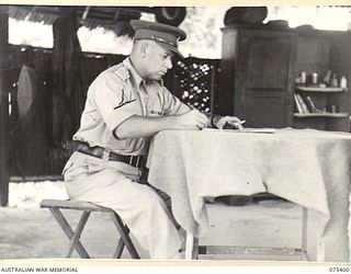 SIAR, NEW GUINEA. 1944-08-19. TX2002 BRIGADIER J. FIELD, DSO, ED, COMMANDING, 7TH INFANTRY BRIGADE AT WORK IN HIS TENT OFFICE