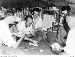 Lae, New Guinea. Patients at the Australian General Hospital enjoy a leisurely game of cards. Left to right: Signalman G. Head of Sydney; Gunner W. Lear of Victoria; Sapper J. Branch, Adelaide; ..