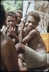 Boys, one smiling and holding something with cloth twisted around it