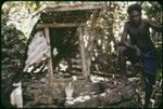 Man leaning on shrine