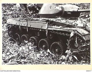 TOROKINA AREA, BOUGAINVILLE. 1945-07-28. AN M24 GENERAL CHAFFEE LIGHT TANK TAKING PART IN TESTS CONDUCTED FOR THE WAR OFFICE. NOTE THE CLOGGING OF THE TANK WHICH OCCURS ONLY AT THE REAR OF THE ..