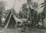 Polynesian women in front of a traditional hut