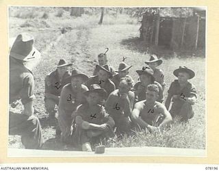 YAKAMUL, NEW GUINEA. 1945-01-09. NX122980 CAPTAIN A.J. MARSHALL, THE ONE ARMED OFFICER IN CHARGE, "JOCK FORCE" AND THE 2/2ND INFANTRY BATTALION (1) LECTURING HIS MEN ON THE NEED FOR SECURITY WHILE ..