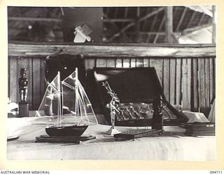 LAE AREA, NEW GUINEA, 1945-08-04. THE WOODWORK AND METALWORK SECTION AT THE ARTS AND CRAFTS EXHIBITION WHICH WAS HELD AT THE RED CROSS SOCIETY HUT, 2/7 GENERAL HOSPITAL. BOTH PATIENTS AND HOSPITAL ..