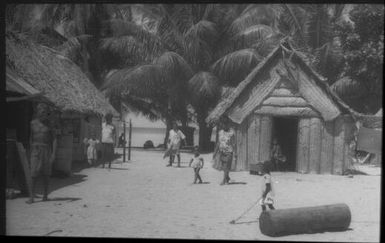 Houses with adults and children : Carteret Islands, Papua New Guinea, 1960 / Terence and Margaret Spencer