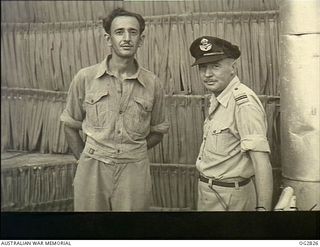 AITAPE, NORTH EAST NEW GUINEA. C. 1945. LEADING AIRCRAFTMAN (LAC) JOHN SHERMAN OF SYDNEY, NSW, WIRELESS MECHANIC (LEFT) AND FLIGHT LIEUTENANT C. J. AMOS, ADJUTANT OF A RAAF BEAUFORT BOMBER SQUADRON ..