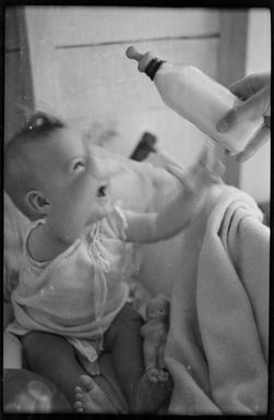 Ray Hare in a bassinet
