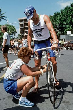 An official inspects Major (MAJ) Gary Castelli's bicycle prior to his participation in the bicycle race, part of the 1987 Ironman Competition. Castelli is a member of the US Air Force