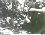 THE SOLOMON ISLANDS, 1945-05. AN AUSTRALIAN SOLDIER BOILING THE BILLY AT NORTH BOUGAINVILLE. (RNZAF OFFICIAL PHOTOGRAPH.)