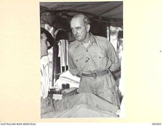 TOROKINA, BOUGAINVILLE. 1945-04-11. SENATOR J.M. FRASER, ACTING MINISTER FOR THE ARMY (2), TALKING TO PRIVATE K.L. HUMPHREYS (1), DURING HIS VISIT TO 2/1 GENERAL HOSPITAL