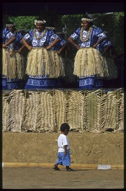 Little boy walking in front of Tokelau performers at the 8th Festival of Pacific Arts, Noumea, New Caledonia