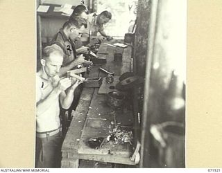 KOITAKI, PORT MORESBY AREA, PAPUA, NEW GUINEA. 1944-03-26. ACTIVITY ON THE CARPENTER'S BENCH AT THE AUSTRALIAN ARMY EDUCATION SERVICE WORKSHOP ATTACHED TO THE 113TH CONVALESCENT DEPOT. IDENTIFIED ..