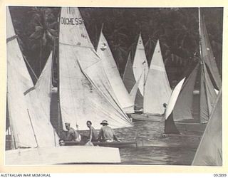 JACQUINOT BAY, NEW BRITAIN. 1945-06-10. YACHTS OF THE ROYAL PACIFIC YACHT CLUB, A CLUB FORMED BY MEN AND OFFICERS IN HEADQUARTERS 5 DIVISION AREA, WHO HAVE BUILT THEIR OWN CRAFT FROM ODDS AND ENDS. ..