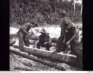 SCARLET BEACH, NEW GUINEA. 1943-10-30. VX60470 SAPPER (SPR) W. SMITH (LEFT), VX35357 SPR R. R. MITCHELL (CENTRE) AND VX69257 SPR R. AYTON ALL OF THE 2/3RD AUSTRALIAN FIELD COMPANY, ROYAL AUSTRALIAN ..