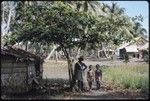 Man and young boys in village